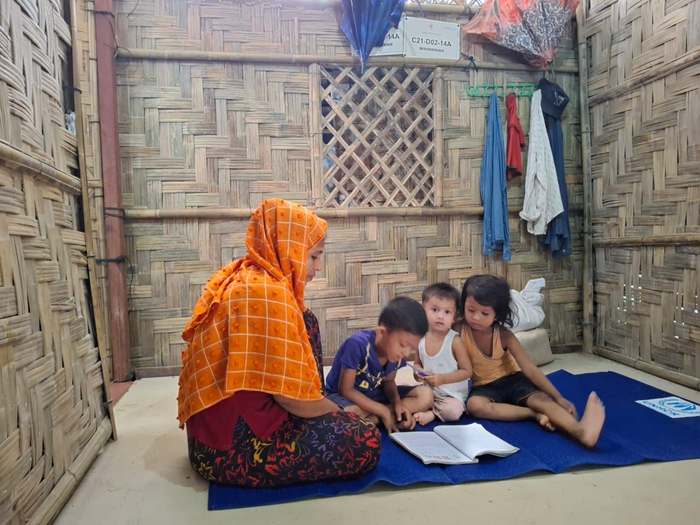 Noor and her three children inside their new shelter