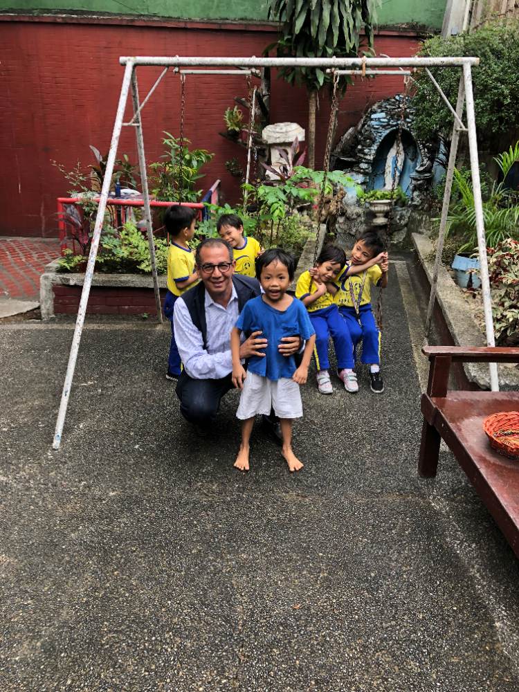 Mohamed Ousri with children at a partner shelter