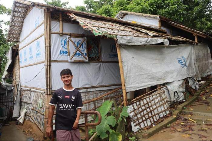 Mohammed Sayed in front of his shelter, Camp 21